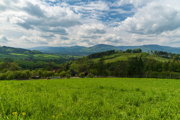 beautiful springtime surrounding of Vendryne village with meadows, hills and dispersed settlement - obrazy, fototapety, plakaty