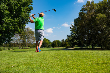 Close up Golfer is driving golf ball to green course