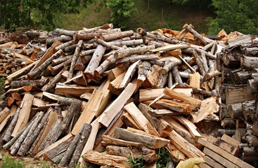 Large pile of chopped firewood prepared for heating the hut in winter