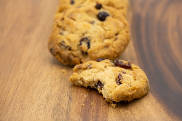 Pile of delicious tasty recipe apple cookies homemade with bite isolated on wooden table