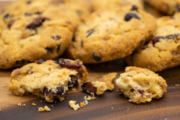 Pile of delicious tasty recipe apple cookies homemade with crack small pieces isolated on wooden table