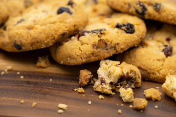 Pile of delicious tasty recipe apple cookies homemade with crack small pieces isolated on wooden table