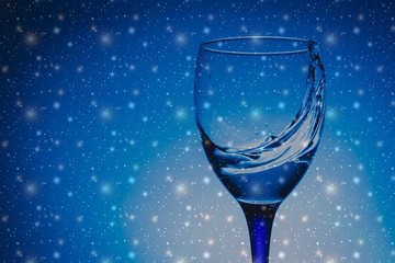wine glass of flying water on blue background