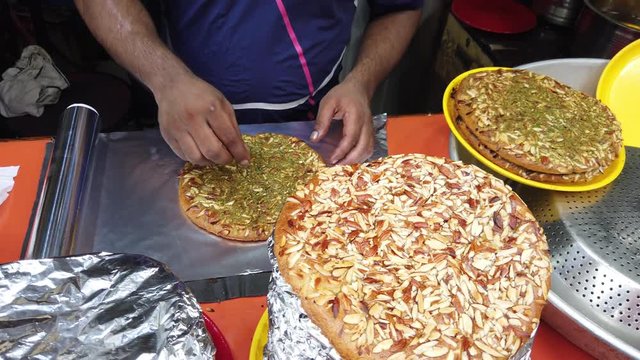 Street vendor selling almond topped Shahi Sheermal or Shirmal, is a saffron-flavored traditional flatbread from Greater Iran. The word sheermal is derived from the Persian words شیر meaning milk, and 