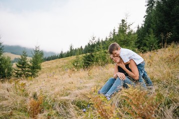Naklejka na ściany i meble Young mom with baby boy travelling. Mother on hiking adventure with child, family trip in mountains. National Park. Hike with children. Active summer holidays.