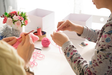 Young attractive girls in a crochet lesson