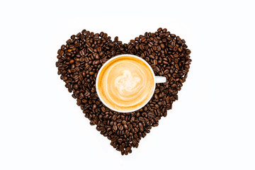A cup of Latte coffee and roasted coffee beans heart shape on white background. Coffee break. Coffee Time.