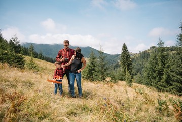Father and child hiking in scenic mountains. Dad and son enjoying the view from the mountain top in Carpathian mountains