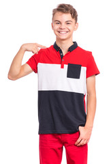 Portrait of handsome teen boy pointing oneself, isolated on white background. Emotions and signs concept. Happy smiling child looking at camera. Young student points finger at himself.