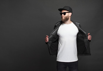 Hipster handsome male model with beard wearing white blank t-shirt and a baseball cap with space...