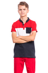 Portrait of confident handsome teen boy posing with crossed arms. Child with hands folded looking at camera. Emotions and signs concept. Young student isolated on white background.
