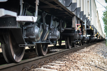 Fototapeta na wymiar Wheels of cargo train on a rail track