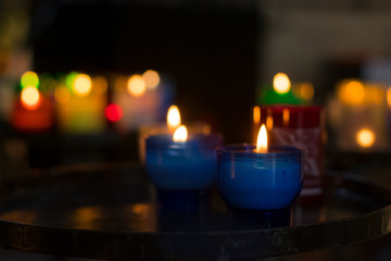 Colorful candles with fire to pray