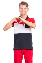 Portrait of smiling teen boy making Heart Gesture with fingers. Happy child with hands in heart shape. Young student showing signs of Love, isolated on white background. Valentines Day concept.
