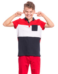 I can not hear anything - portrait of young caucasian teen boy covering ears. Funny teenager 15 year old. Child isolated on white background. Boy closing ears with fingers. Hear no evil concept.