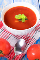 Tomato soup on wooden table.