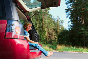 happy cute boy enjoy travel by car in nature