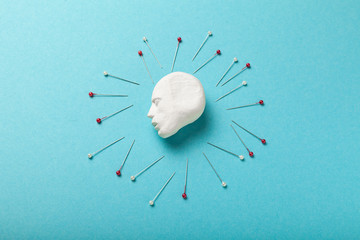 Headache concept, needles surround head. Pain and stress, migraine.