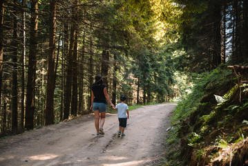 Obraz premium mother and son having rest on vacation in mountains