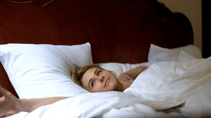Adorable woman waking up in morning, comfortable healthy sleep for beauty