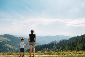 mother and son having rest on vacation in mountains