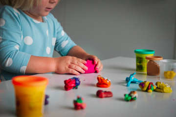 Child playing with clay molding shapes, kids crafts