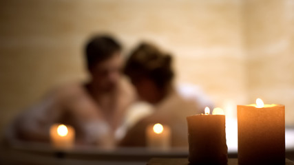 Woman and her beloved man having bath, couple spending time in cozy bathtub
