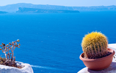 Beautiful view of white typical village and Aegean Sea i. View of blue domed churches -famous tourist attraction in Greece.