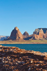 The golden red rocks on the shores of the lake powell landscape/.
