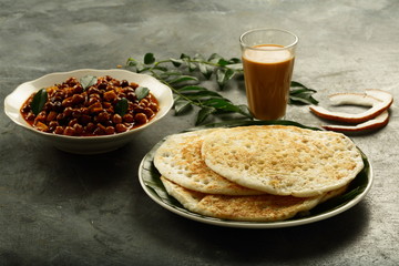 Kerala breakfast,rice dosa,pancake served with chickpea,kadala curry and milk tea.