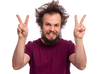Portrait of handsome bearded man making Victory gesture, isolated on white background. Happy crazy male smiling and showing victory sign. Caucasian man with funny haircut doing victory symbol.
