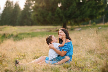 Fototapeta premium mother and son having rest on vacation in mountains