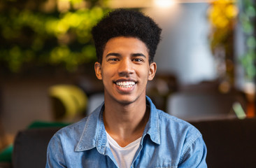 Portrait of cheerful afro teenager smiling at camera