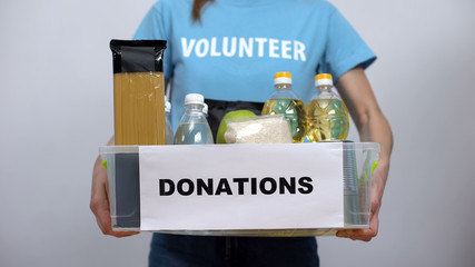 Hands putting food staff donation box, volunteer provision project charity event
