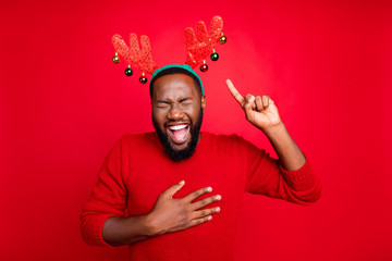 Theme party concept. Portrait of funky man with black beard pointing at his deer costume laugh at...