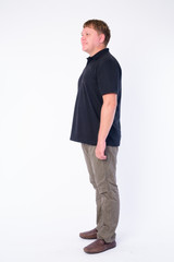 Fototapeta premium Full body shot profile view of happy overweight man smiling