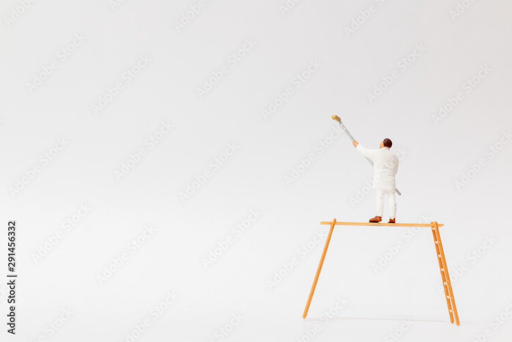 Wall mural miniature people : painter holding a brush with space for text