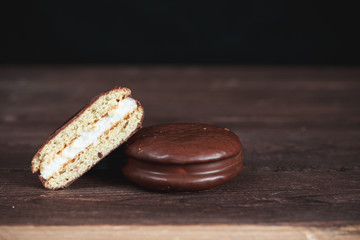 Chocolate chip cookies on a dark wooden table. Cookies cut in half. Background image. Tasty...