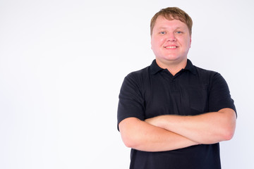 Portrait of happy overweight man smiling with arms crossed