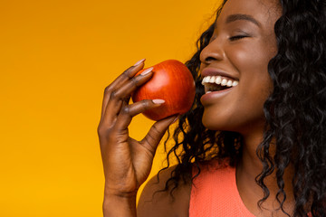 Close up portrait of young lady enjoying her apple