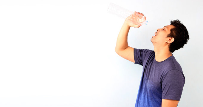 Attractive handsome asian man gets thirsty because of hot weather in the summer season on White background With copy space.