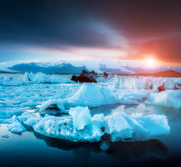 Magical landscape with ice depths in the famous Jokulsarlon glacial lagoon in Iceland at sunset. Exotic countries. Amazing places. Popular tourist atraction. (global warming – concept)