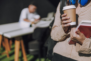 Female student is having coffee break indoors