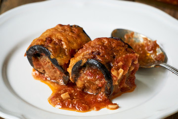 Eggplant rolls with minced meat and cheese in tomato sauce
