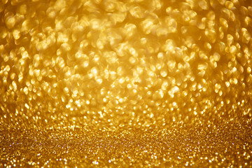 Gold glittering christmas lights. Blurred abstract background.