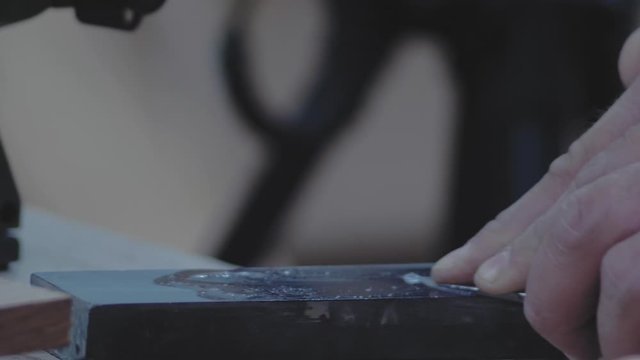 manual grinding of a joiner's knife on a grindstone. 4k. 4k video. slow motion. 24 fps