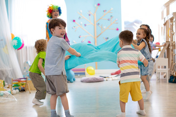 Children standing in circle and waving canvas