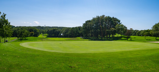 Panorama View of Golf Course with beautiful putting green. Golf course with a rich green turf...