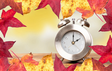 clock for time change to winter time and colorful background