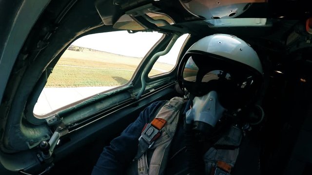 Pilot in a helmet and mask on the plane